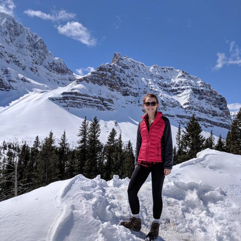 Kathryn standing among the snowy mountains in Banff